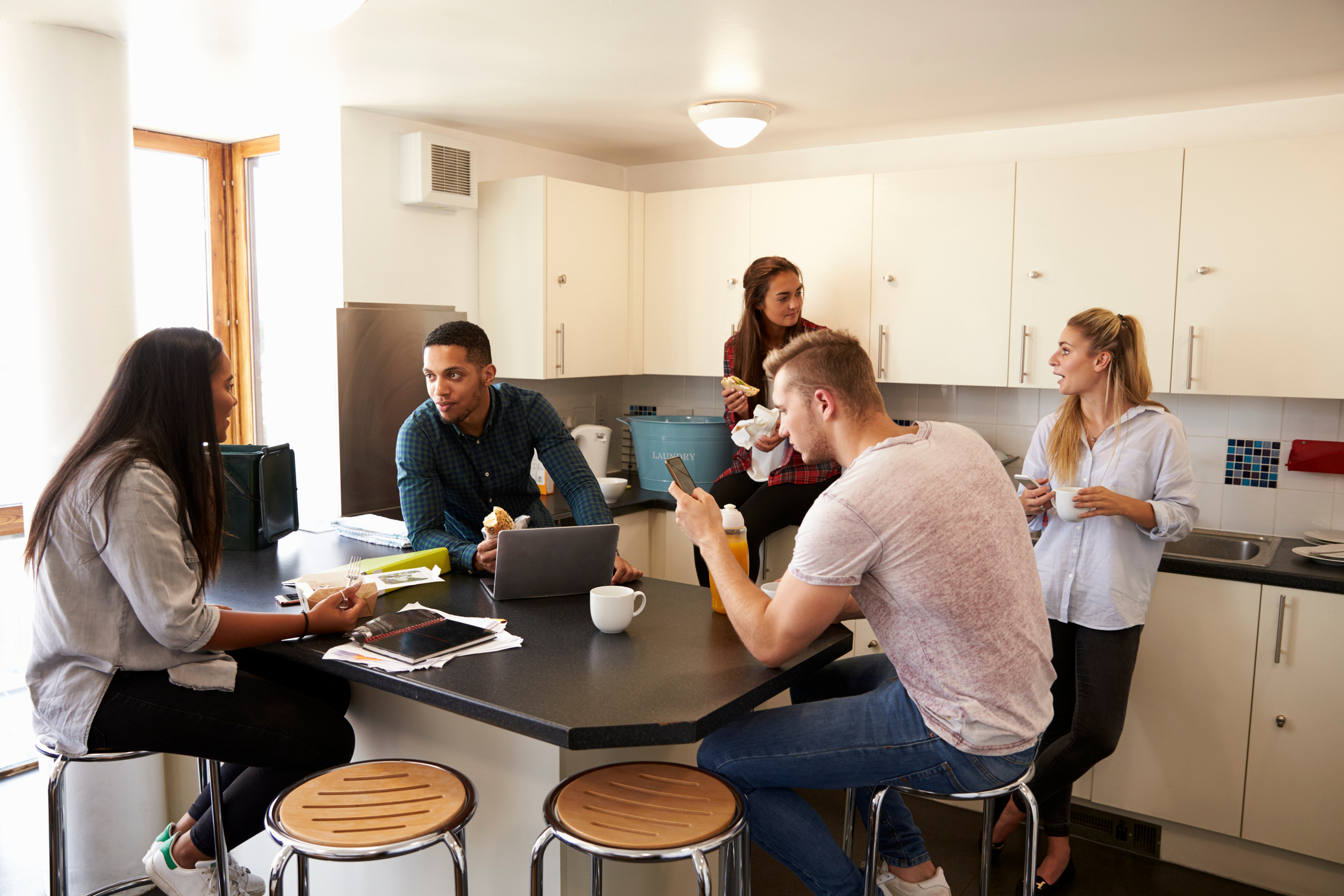 Students Relaxing in Kitchen of Shared Accommodation